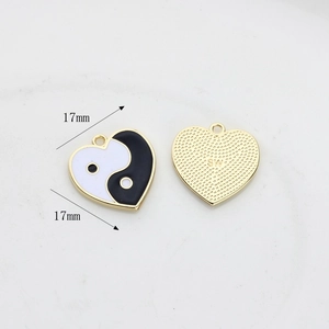 Macro detail of 17mm heart-shaped Yin Yang charm showing front enamel and back texture