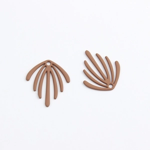 Macro shot of two brown sea leaf pendants with matte texture and hanging holes for DIY jewelry