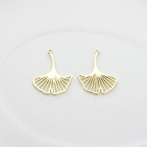 Detailed view of hollow ginkgo leaf alloy pendants with golden finish for DIY jewelry