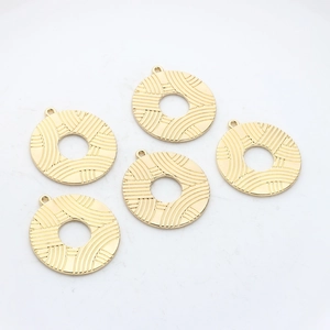 Five gold plated hollow circular pendants with radial texture for jewelry making