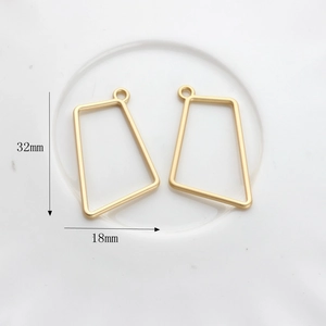 Detailed size view of irregular geometric trapezoid matte gold pendants, 32mm by 18mm