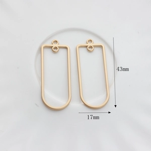 Detail of matte gold geometric rectangular frames with size markings 43mm by 17mm