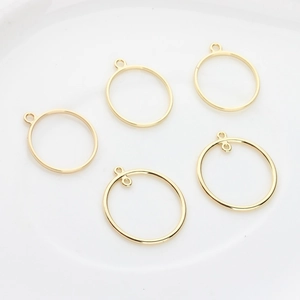 Five pieces of gold alloy hollow circle pendants with single and double loop connectors