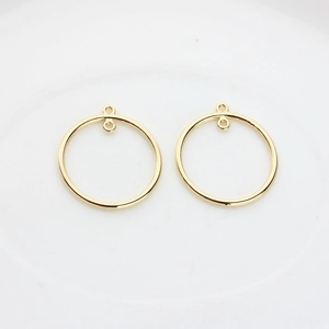 Close-up of golden hollow circle alloy charms for DIY earring and jewelry making