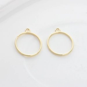 Close-up of minimalist golden alloy hollow circle charms for DIY earring making