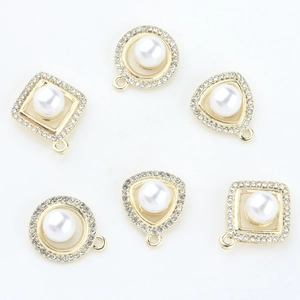 Macro view of gold-plated geometric pendants with embedded pearls and rhinestones