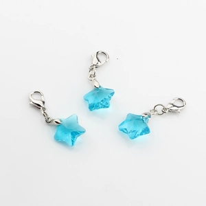 Close-up of three blue faceted crystal star pendants with silver lobster clasps