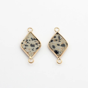 Detail of rhombus Dalmatian Jasper charms with gold-plated edges and double loops
