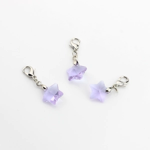 Detail of purple star crystal charms with silver lobster clasps for handmade crafts