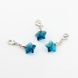 Detail view of deep blue faceted crystal star charms with silver lobster clasps