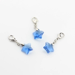 Macro view of blue faceted crystal star pendants with silver lobster clasps for kids