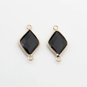Macro detail of rhombus natural stone pendant with gold edges and double bail connectors