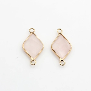 Detail of faceted pink natural stone connector with gold plated edges for DIY jewelry