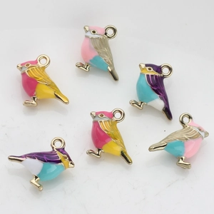 Detail view of colorful bird-shaped enamel alloy charms for DIY jewelry making sets