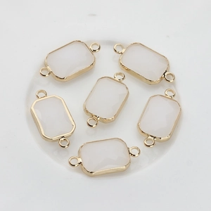 Detailed view of six white rectangular crystal charms with gold-plated copper frames for DIY