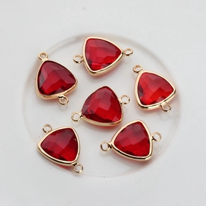 Macro view of six red faceted triangle crystal pendants with gold plated double loops