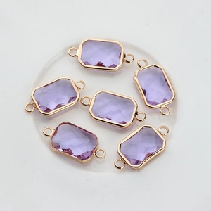 Detailed view of six lavender rectangular crystal connectors with gold plated copper borders