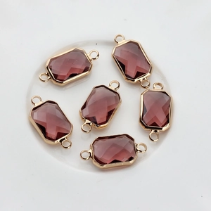 Detailed view of six rectangular purple crystal pendants with gold metal hanging loops