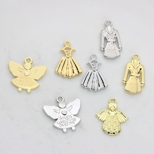 7-piece gold and silver alloy pendant set featuring angels, dresses, and trench coat styles