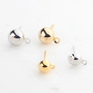 Macro detail of gold and silver plated ball stud earrings with hanging loops for DIY jewelry