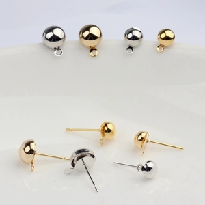Macro view of 14K gold-plated ball ear studs with hanging loops for DIY jewelry making