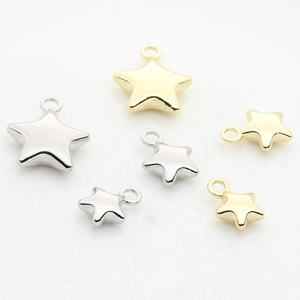Detailed view of alloy star pendants in gold and silver finishes for DIY jewelry making
