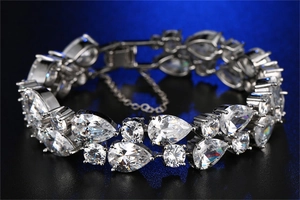 Detailed shot of double-row luxury silver bracelet with cubic zirconia and safety chain