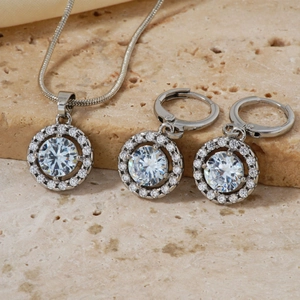 Makro-Detail des Brautschmuck-Sets mit Zirkonia auf beigem Stein mit Glanzeffekt