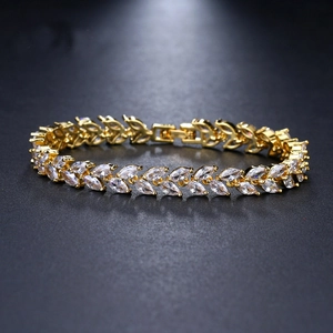 Detailed view of marquise-cut zircons set in leaf-shaped gold plated links on a bracelet