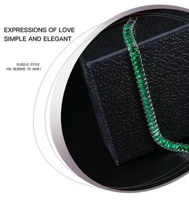 Macro view of emerald green rectangular zircon tennis bracelet on black jewelry box
