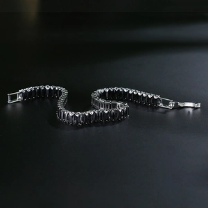 Macro shot of gun-black zircon bracelet featuring rectangular cut crystals and folding clasp