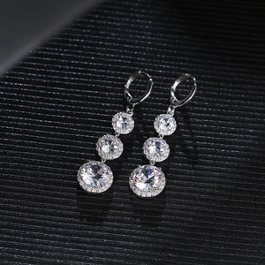 Elegant drop earrings featuring three graduated round diamonds with a halo setting in silver