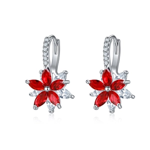 Détail de boucles d'oreilles fleurs double couche avec pierres rouges et zircons