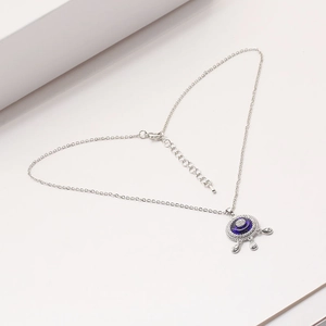 Detail of blue evil eye pendant necklace with teardrop charms and adjustable lobster clasp