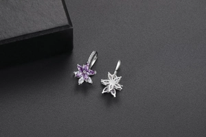 Détails macro des boucles d'oreilles fleurs double couche en argent et zircons violets