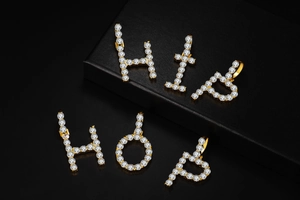 Macro detail of gold plated Hip Hop pendant set with sparkling cubic zirconia stones