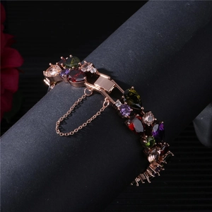 Elegant rose gold bracelet featuring colorful pear-cut cubic zirconia and safety chain