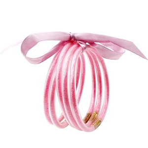 Set de cinco pulseras de silicona con purpurina rosa, lazo de satén y cierres dorados