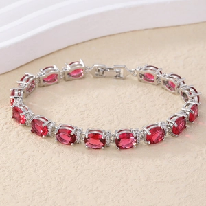 Detailed view of vintage silver chain with red oval gemstones and crystal accents