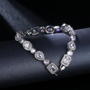Macro shot of sparkling silver-tone bracelet featuring multi-cut rhinestones and fold-over clasp