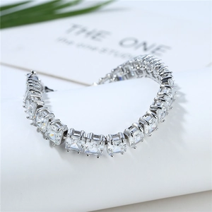Elegant silver tennis bracelet with square-cut zircons on a minimalist display