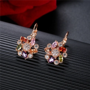 Colorful floral zircon earrings with rose gold finish shown on a dark textured surface