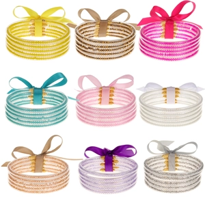 Set de 5 brazaletes de silicona con purpurina decorados con lazo y colgante de metal