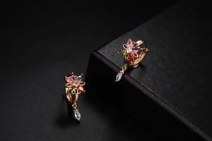Macro shot of colorful floral earrings with teardrop gemstones and marquise zircon drops
