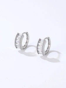 Macro shot of silver hoops with step-cut zircons and secure clasp closure detail