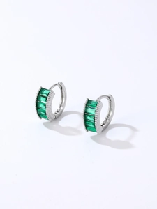 Detail view of silver earrings featuring five rectangle-cut emerald green zircons