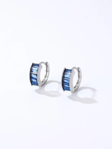 Close-up of silver-tone hoop earrings with rectangular dark blue zircon stones