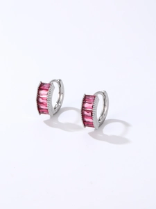 Detailed close-up of silver hoop earrings featuring baguette-cut pink zircons in row setting