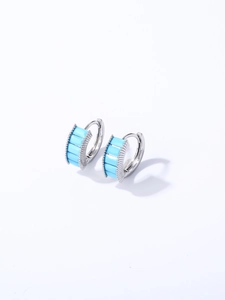 Close-up of silver hoop earrings featuring five rectangular light blue zircon gemstones