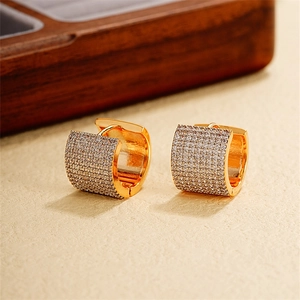 Detail of 18k gold plated wide hoop earrings with multi-row pavé zircon settings